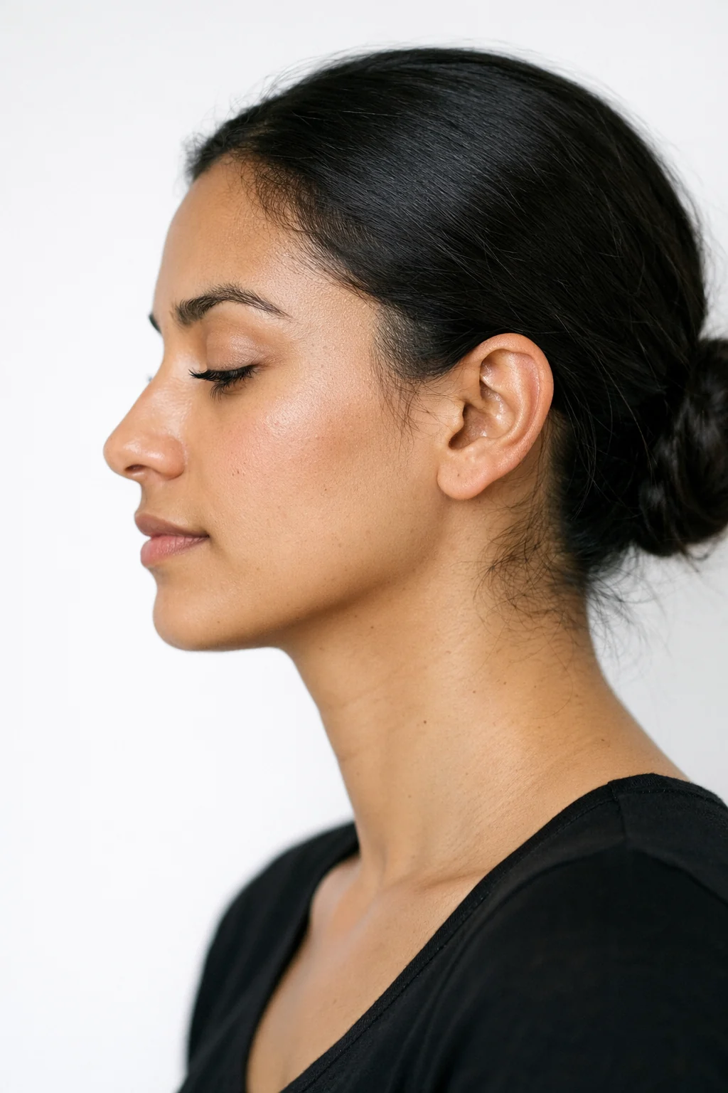 A model photographed in profile, nose and brow line in frame